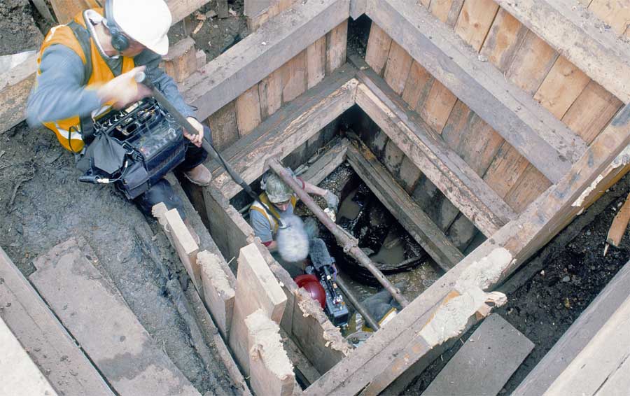 The bottom of the west well finally reached Time Team director and cameraman Graham Johnston and Ian Blair discussing the halved barrel and its contents